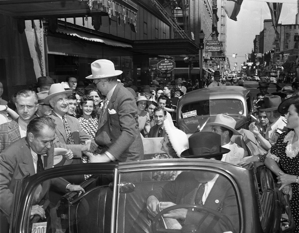 Sept. 20, 1940: Following a parade on 7th Street in downtown Fort Worth, movie studio mogul Samuel Goldwyn shakes hands with Amon Carter, owner of the Star-Telegram. In car is Mrs. Goldwyn and Gary Cooper, star of the movie “The Westerner,” partially filmed in and around Fort Worth.