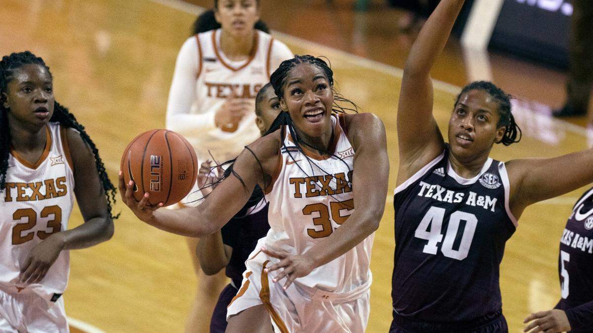 In this Dec. 6, 2020, photo, Texas center Charli Collier (35) goes up to shoot against Texas A&M center Ciera Johnson (40) during the first half of an NCAA college basketball game in Austin, Texas. The Dallas Wings selected Collier with the first pick in the WNBA draft Thursday, April 15.