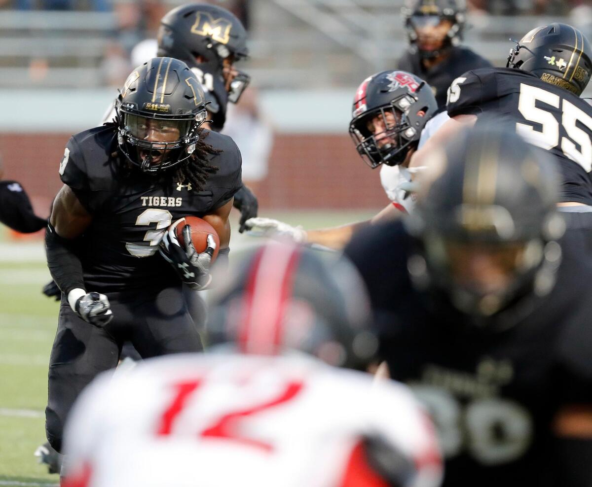 Mansfield running back James Johnson (3) looks for a way out of the backfield in the first half of a high school football game at Newsom Stadium in Mansfield, Texas, Friday, Sept. 16, 2022. Mansfield led Legacy 16-6 at the half. (Special to the Star-Telegram Bob Booth)