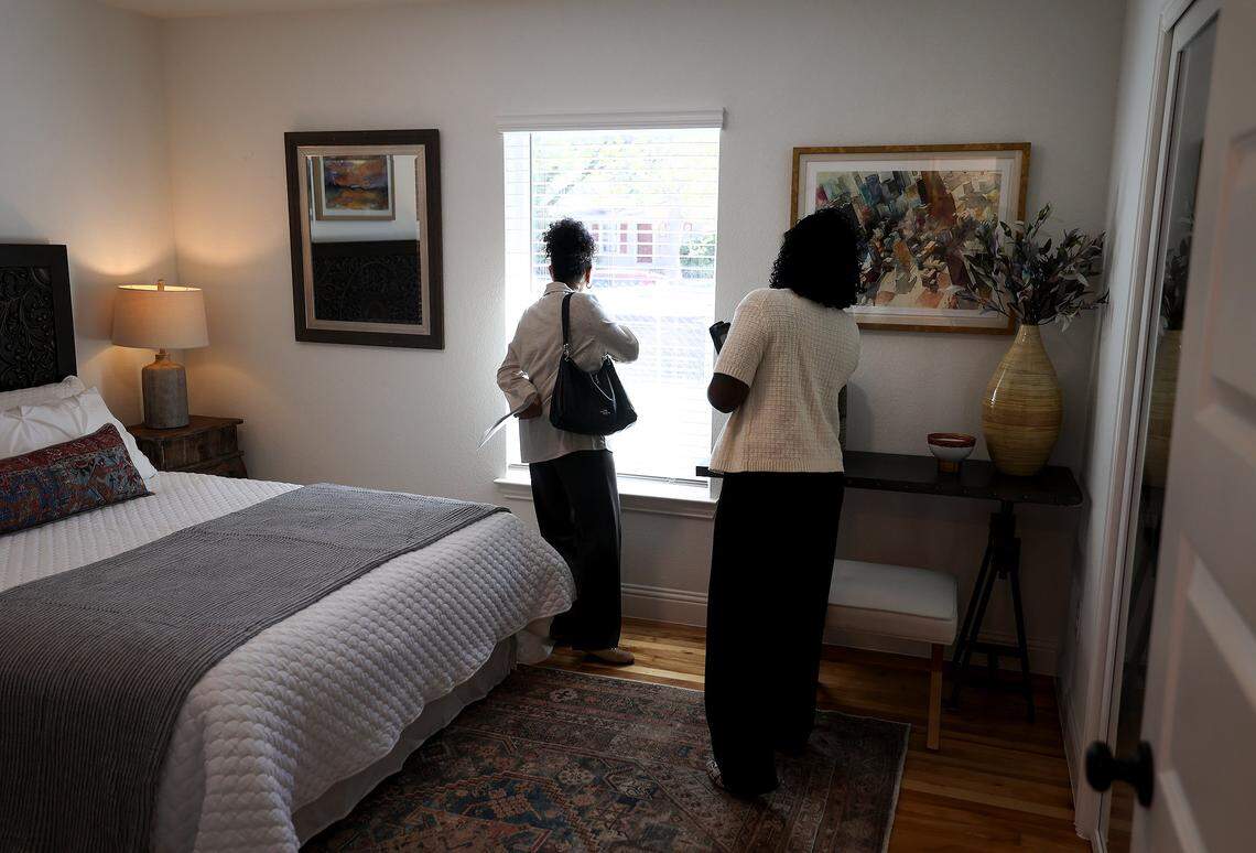 Larshá Thomas, left, and Angella Jones with SouthState Bank, who have many first time home buyers as clients, tour a model home at Carroll Park in Fort Worth on Tuesday, Sept. 23, 2025. Carroll Park is the Fort Worth Land Trust's inaugural project for the city.