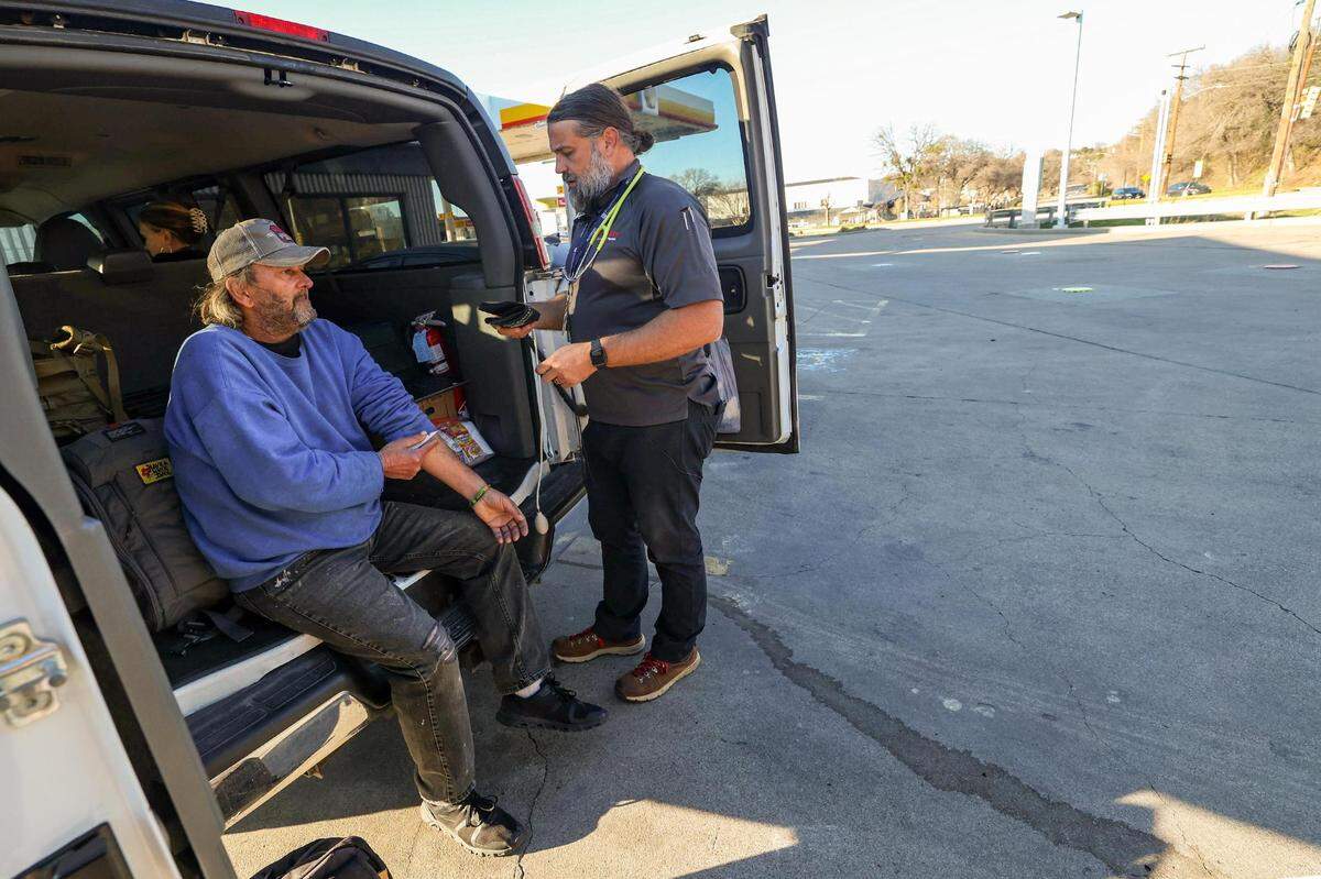 Glen Hanes gets his blood pressure monitored by street medicine team leader Joel Hunt during a patient visit at a Shell Gas Station in Fort Worth on Jan. 9. Hanes, 50, met Hunt in 2010 when he expressed concern for a bad cough and have been in touch frequently ever since.