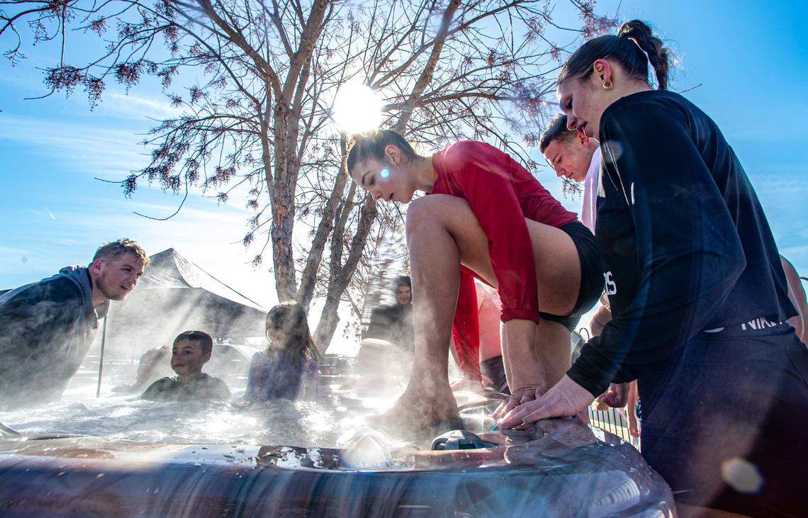 Annika Mijuskovic, in a red shirt, steps into a 104-degree hot tub after her plunge into Lake Granbury during Goosebump Jump Saturday, Jan. 20, 2024. “It was colder than I thought,” Mijuskovic said.