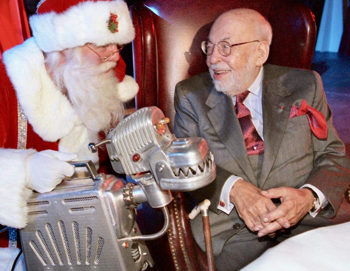 During the unveiling of the Neiman Marcus 2000 Christmas Book, Santa Claus, left, shows off a robot dog made out of discarded home appliances to Stanley Marcus. The Robot Family is one of the many unique gifts, shown Sept. 25, 2000.