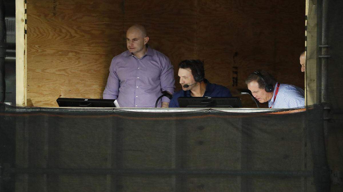 Former Cowboys quarterback Tony Romo, middle, and broadcast partner Jim Nantz, right, used Thursday night's Hall of Fame game presumably to practice their broadcasting skills for the upcoming season. Romo worked out of a wood booth behind the end zone.