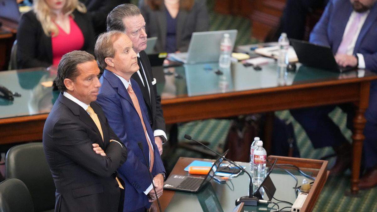 Attorney General Ken Paxton, middle, with his attorneys Tony Buzbee, left, and Dan Cogdell, pleads not guilty at the Capitol on Tuesday September 5, 2023.