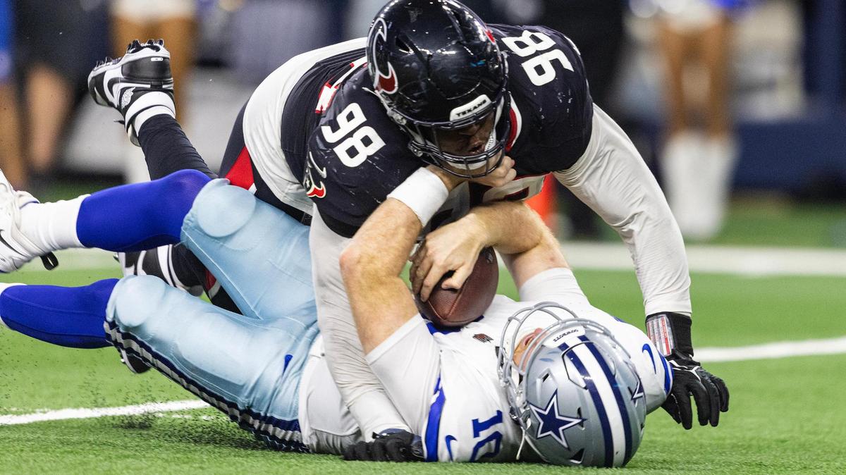 Texans defensive tackle Tim Settle Jr. (98) sacks Cowboys quarterback Cooper Rush (10) in the second half of an NFL game between the Dallas Cowboys and the Houston Texans at AT&T Stadium in Arlington on Monday, Nov. 18, 2024.