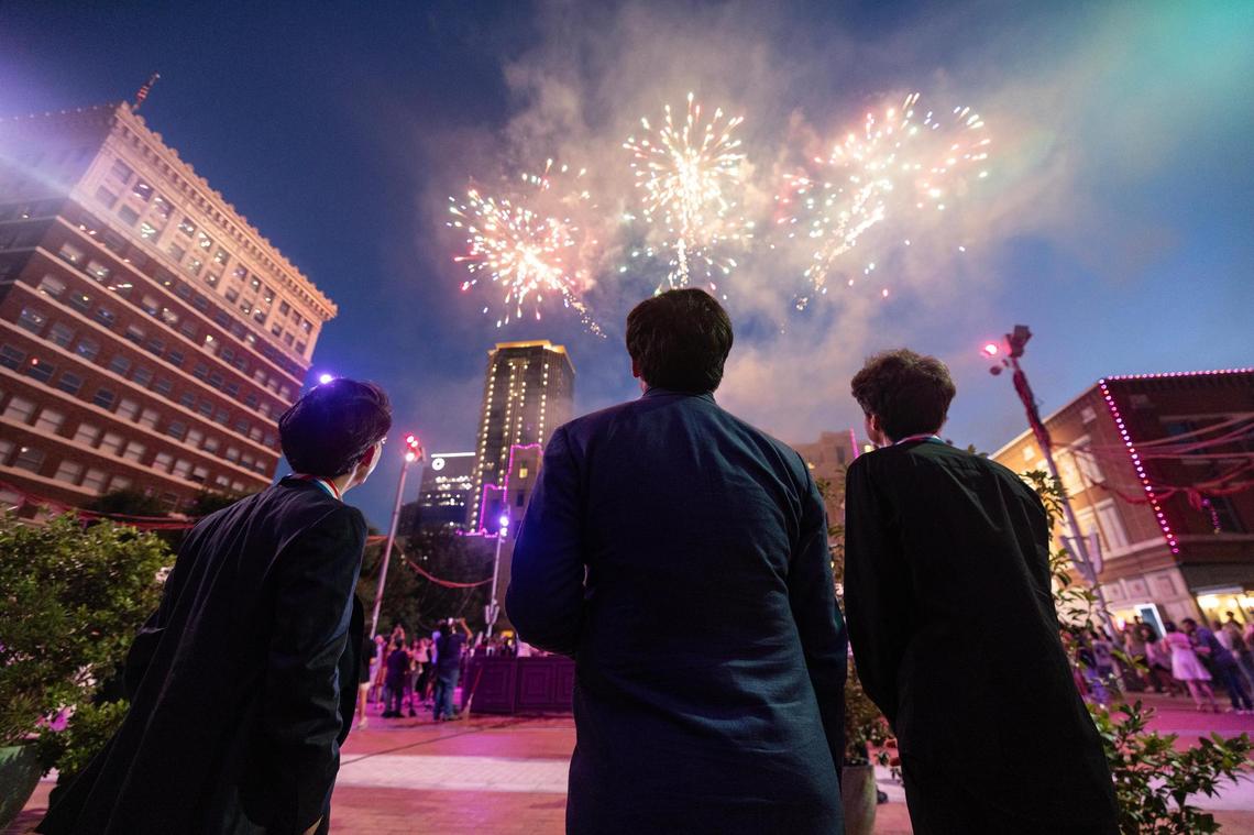 Gold medalist Aristo Sham, left, bronze medalist Evren Ozel, middle, and silver medalist Vitaly Starikov, right, watch the firework show celebration following the Van Cliburn International Piano Competition Awards Ceremony at Sundance Square in Fort Worth on Saturday, June 7, 2025.
