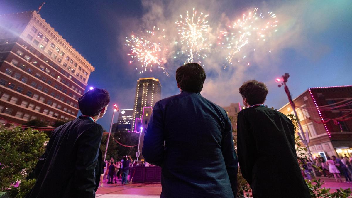 Gold medalist Aristo Sham, left, bronze medalist Evren Ozel, middle, and silver medalist Vitaly Starikov, right, watch the firework show celebration following the Van Cliburn International Piano Competition Awards Ceremony at Sundance Square in Fort Worth on Saturday, June 7, 2025.