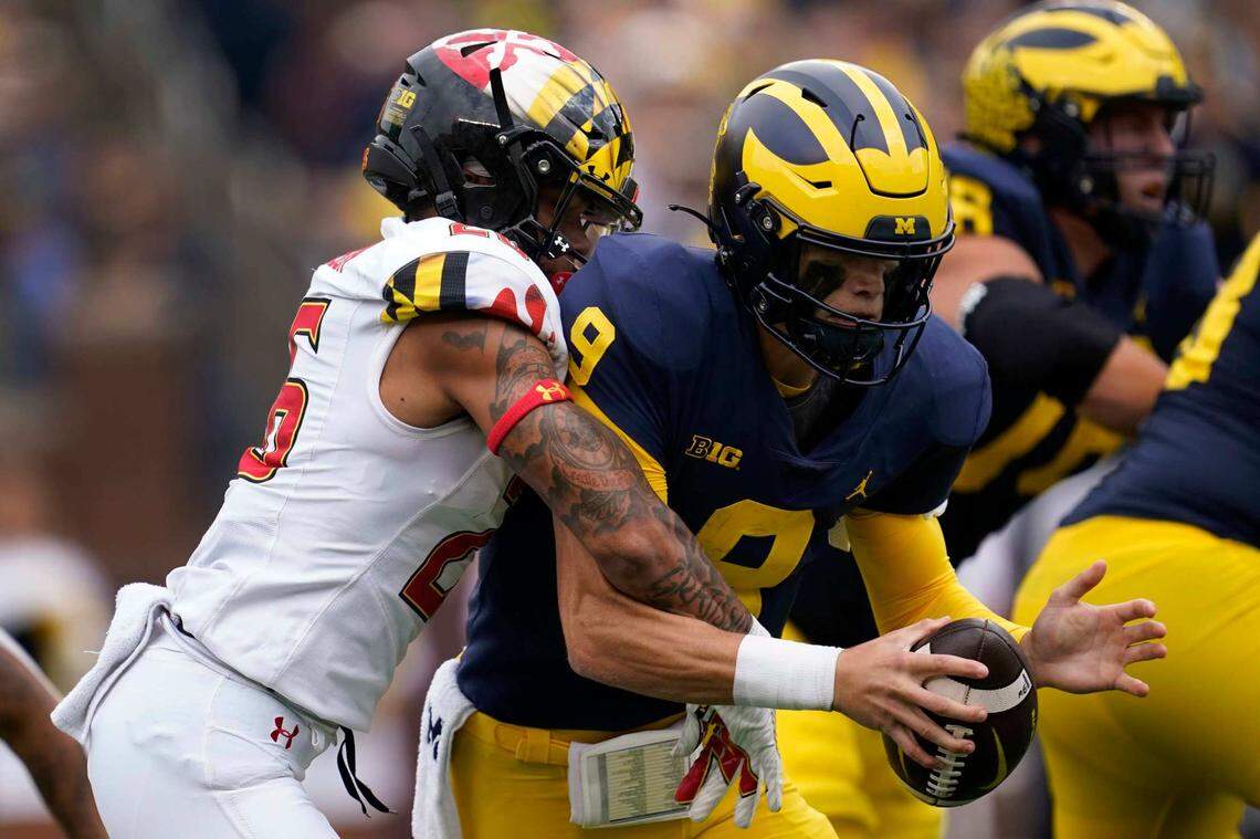 Maryland defensive back Gavin Gibson (26) sacks Michigan quarterback J.J. McCarthy (9) on Sept. 24. The Terps nearly upset the Wolverines.