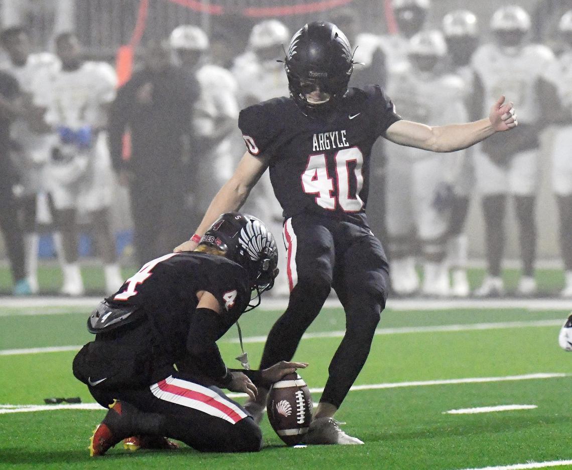 Argyle’s Colton Roquemore, left holds the football asCarter Buxton kicks a 27 yard field goal to cut the South Oak Cliff lead 7-3 in the third quarter of Friday’s December 9, 2022 5A Division 2 State Semifinals playoff football game at the Crowley ISD Multi-Purpose Stadium in Fort Worth, Texas. South Oak Cliff won 14-6.Special/Bob Haynes