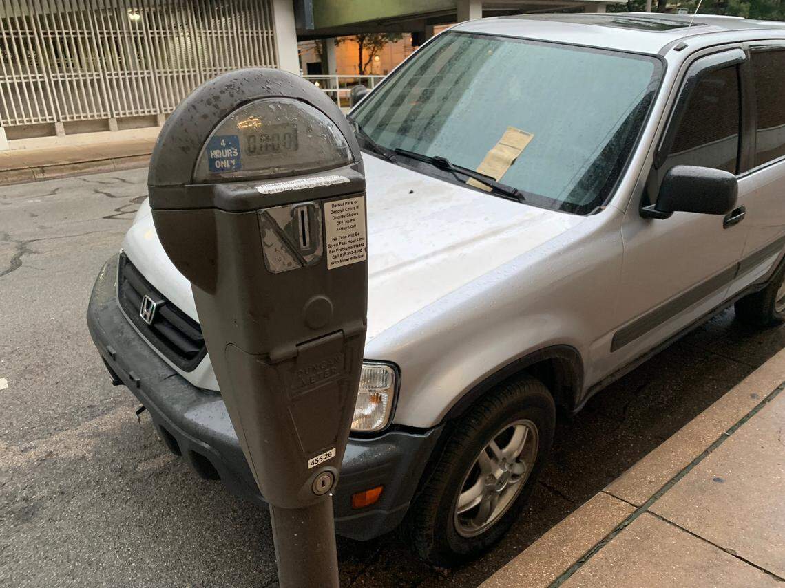 A car parked on Fifth Street in downtown Fort Worth gets a parking meter citation.