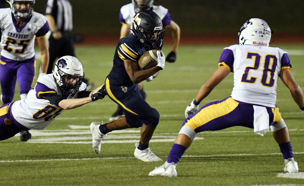 Grranbury’s Andrew Brown, left and Blake Ridriquez right try to stop Arlington Heights’s Lamarcus White as he runs for a first down in the first quarter of their Division 1 District 3-5A football game Thursday, November19, 2020 at Farrington Field in Fort Worth, Texas. Special/Bob Haynes