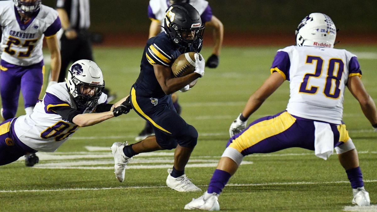 Grranbury’s Andrew Brown, left and Blake Ridriquez right try to stop Arlington Heights’s Lamarcus White as he runs for a first down in the first quarter of their Division 1 District 3-5A football game Thursday, November19, 2020 at Farrington Field in Fort Worth, Texas. Special/Bob Haynes