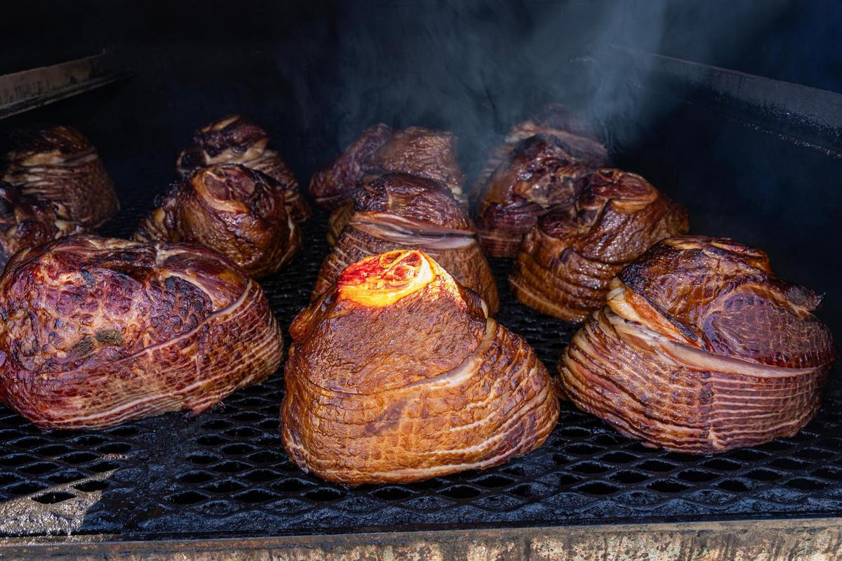 Smoked holiday hams are prepared for Thanksgiving orders at Panther City BBQ in Fort Worth on Wednesday, Nov. 20, 2024. Panther City BBQ landed a spot on the Michelin recommended list making it one of the three restaurants Fort Worth to make the prestigious catalog.