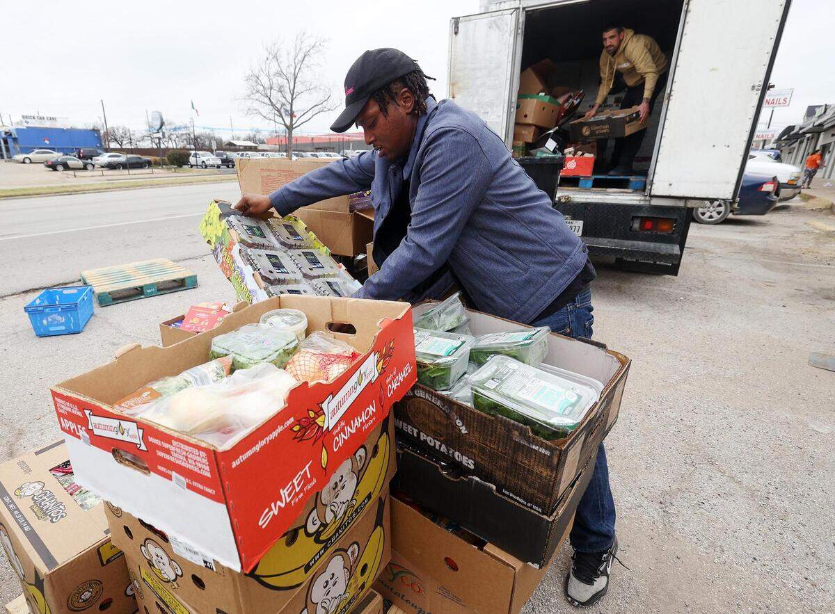 Von Williams, left, and William Gibbs unload food from the back of a truck to be sorted and distributed those in need at Eastside Ministries on Friday, February 2, 2024, in Fort Worth. Food is distributed every weekday, a change since fires destroyed the nonprofit’s food pantry in November.