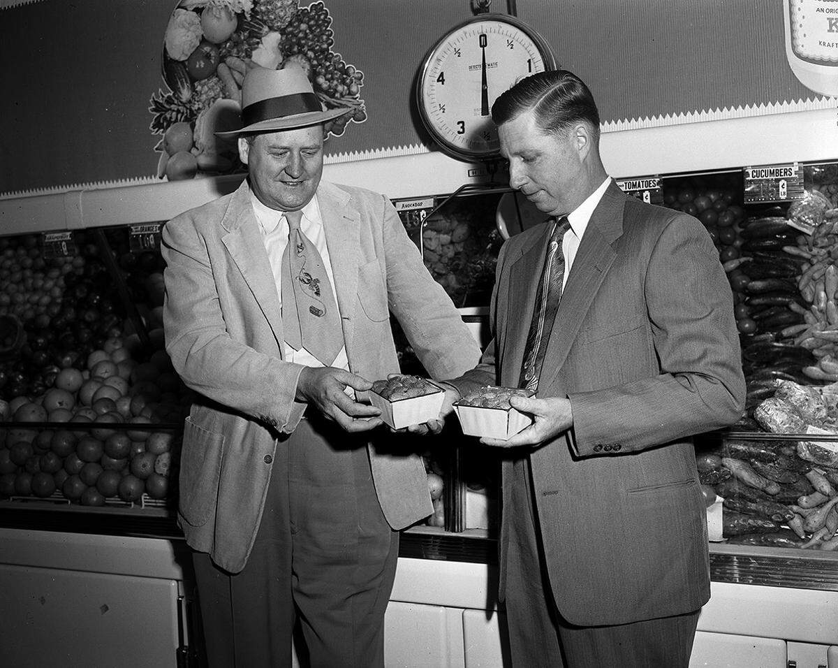 Jan. 13, 1953: L.L. Raspberry, left, and L.L. Cannon, owners of the Berry Street Super Markets, examine some of the fresh produce that is brought twice a week for sale in one of their stores. The market at 1208 E. Berry St. has been reopened after being remodeled. It was burned in a fire that happened on Oct. 24. (The site today is home to a tire store and A&K Food Store.)