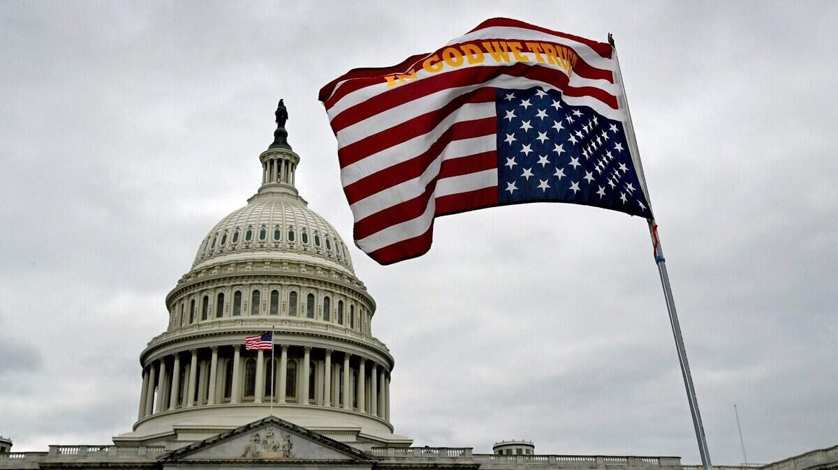 An upside down flag waves in front of the U.S. Capitol on Jan. 6, 2021. The distress signal have been cropping up of late as a symbol of protest from activists unhappy with the Supreme Court decision to overturn Roe v. Wade to the prosecution of former President Donald J. Trump.