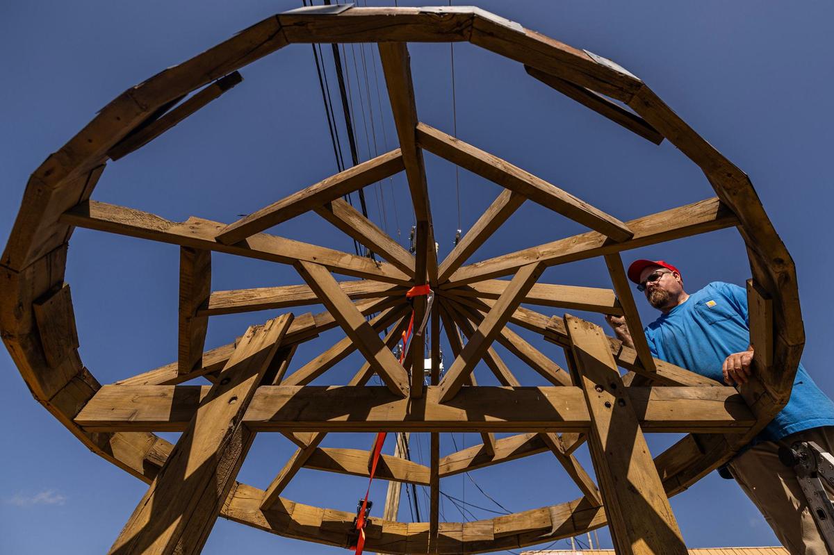 David Hammonds takes out nails in the roof of the Bedford Well during its restoration in Bedford on Saturday.