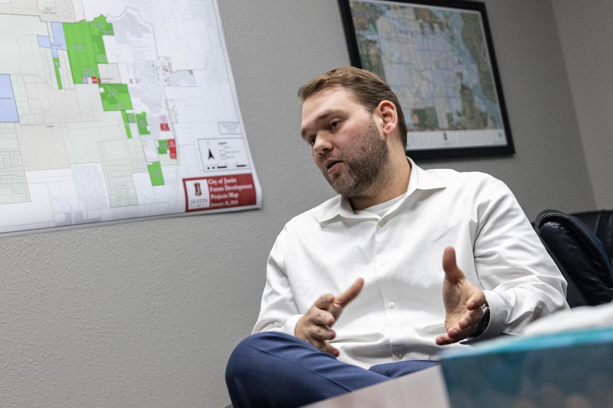 Matthew Cyr, Justin’s development czar, describes how the city has tried to manage its rapid growth in recent years during a meeting at Justin City Hall on Jan. 15.