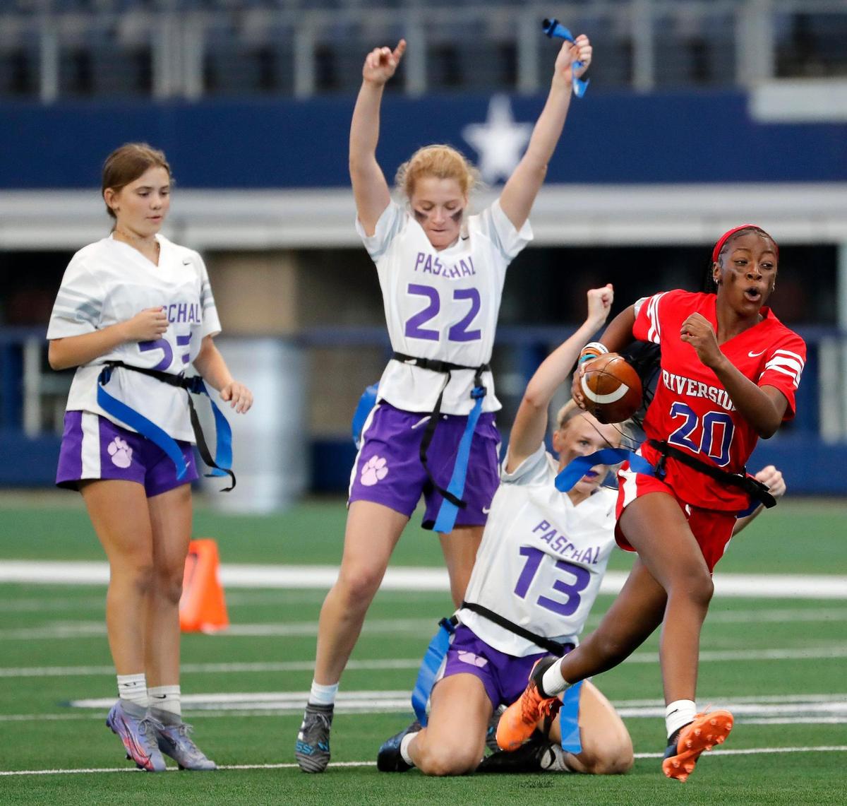 Paschal’s Anne Schuster holds up Carter-Riverside’s Jercarra Hughes’ flag during a Fort Worth ISD flag football game at ATT Stadium in Arlington, Texas, Wednesday, May 18, 2022. Paschal defeated Carter Riverside 33-13. (Special to the Star-Telegram Bob Booth)