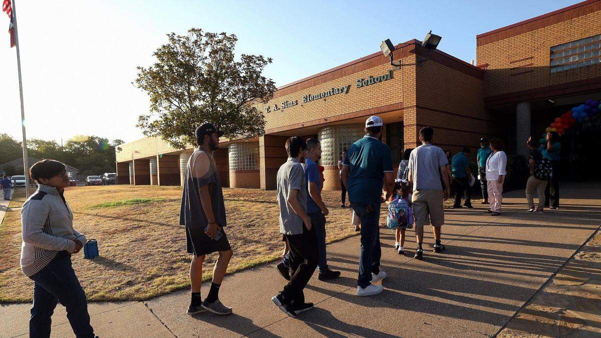 Parents and children arrive at T.A. Simms Elementary School for the first day of school on Monday, August 14, 2023, in Fort Worth.