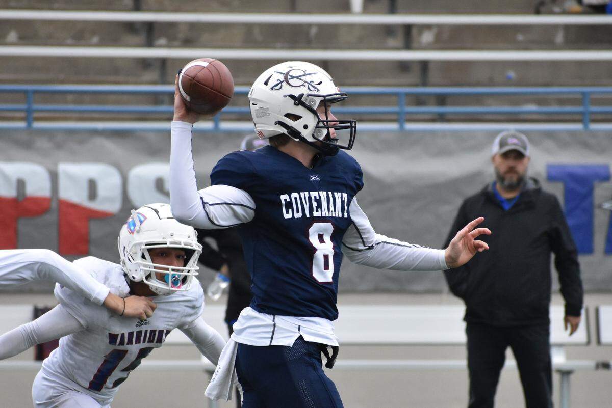 Covenant Classical quarterback Lanham Briley gets a pass off just before being hit by Pasadena First Baptist’s Dallas Post in the first half of the TAPPS Division II 6 Man state championship game. The Cavaliers defeated First Baptist 68-30 on Thursday, December 1, 2022 at Waco ISD Stadium. Courtesy Antony Blalock/txhsfb.net