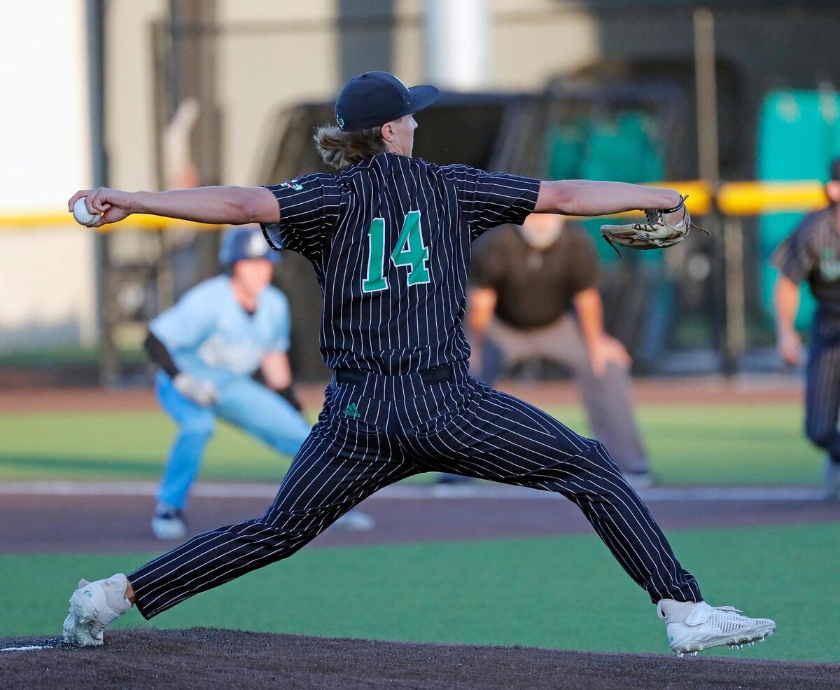 Carroll’s Griffin Herring (14) works the first inning during a UIL 6A Region I bi-district playoff baseball game at Carroll Senior High School in Southlake, Texas, Thursday, May 05, 2022. Herring threw a complete game with 112 pitches. Carroll defeated Bell to move on to the area round. (Special to the Star-Telegram Bob Booth)