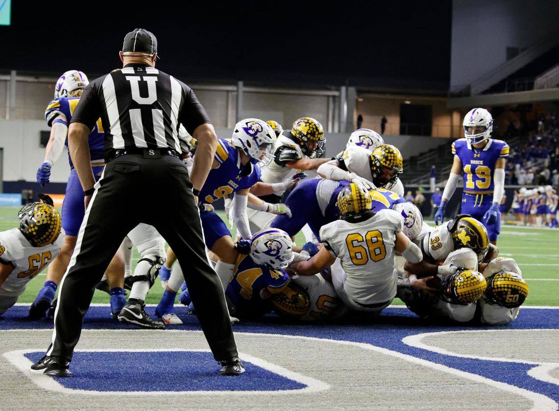 Malakoff quarterback Mike Jones (12), second from the right, puts in the winning touchdown during the second half of a UIL Conference 3A Division 1 semifinal playoff football game at The Ford Center in Frisco, Texas, Thursday, Dec. 07, 2023.