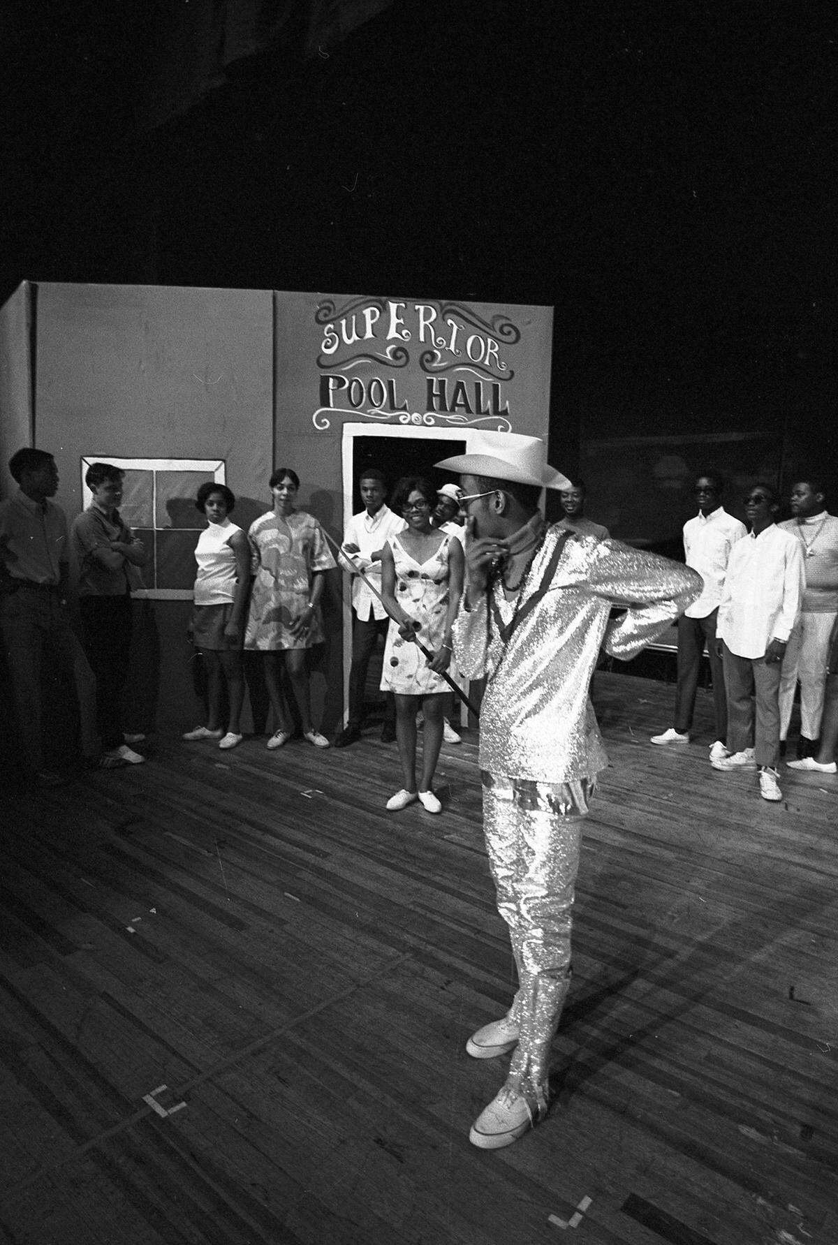 Aug. 27, 1968: Carrie Hunt catches a cue stick from the “Cap Kid,” played by Howard White, and in turn is caught by John English in rehearsals for “Caparama” produced by the Community Action Agency. The musical revue and dramatic sketches will be in Ed Landreth Auditorium.