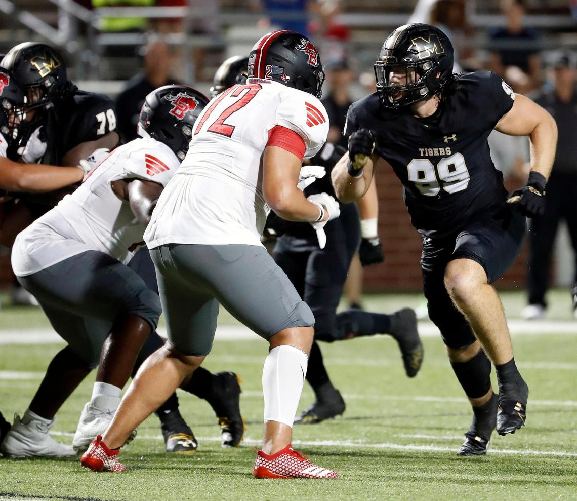 Mansfield defensive lineman Kaleb James (99) gets double teamed at the line in the second half of a high school football game at Newsom Stadium in Mansfield, Texas, Friday, Sept. 16, 2022. Mansfield defeated Legacy 37-16. (Special to the Star-Telegram Bob Booth)