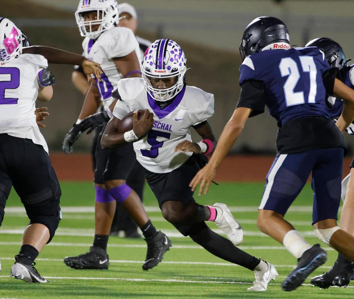 Paschal quarterback Jashaun Thomas (5) hits the hole during a District 4-5A Division 1 football game at Herman Clark Stadium in Fort Worth, Texas, Thursday, Oct. 24, 2024.