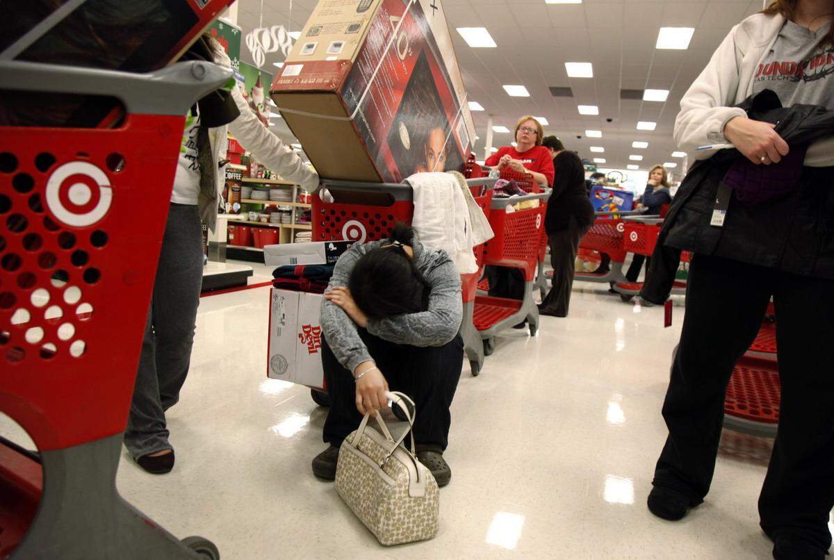 2010: Trinh Pham, 22, of Arlington takes a rest while she waits in line at Target in Allen, Texas, after waiting in line since 9 p.m. on Thursday night to take advantage of Black Friday deals.