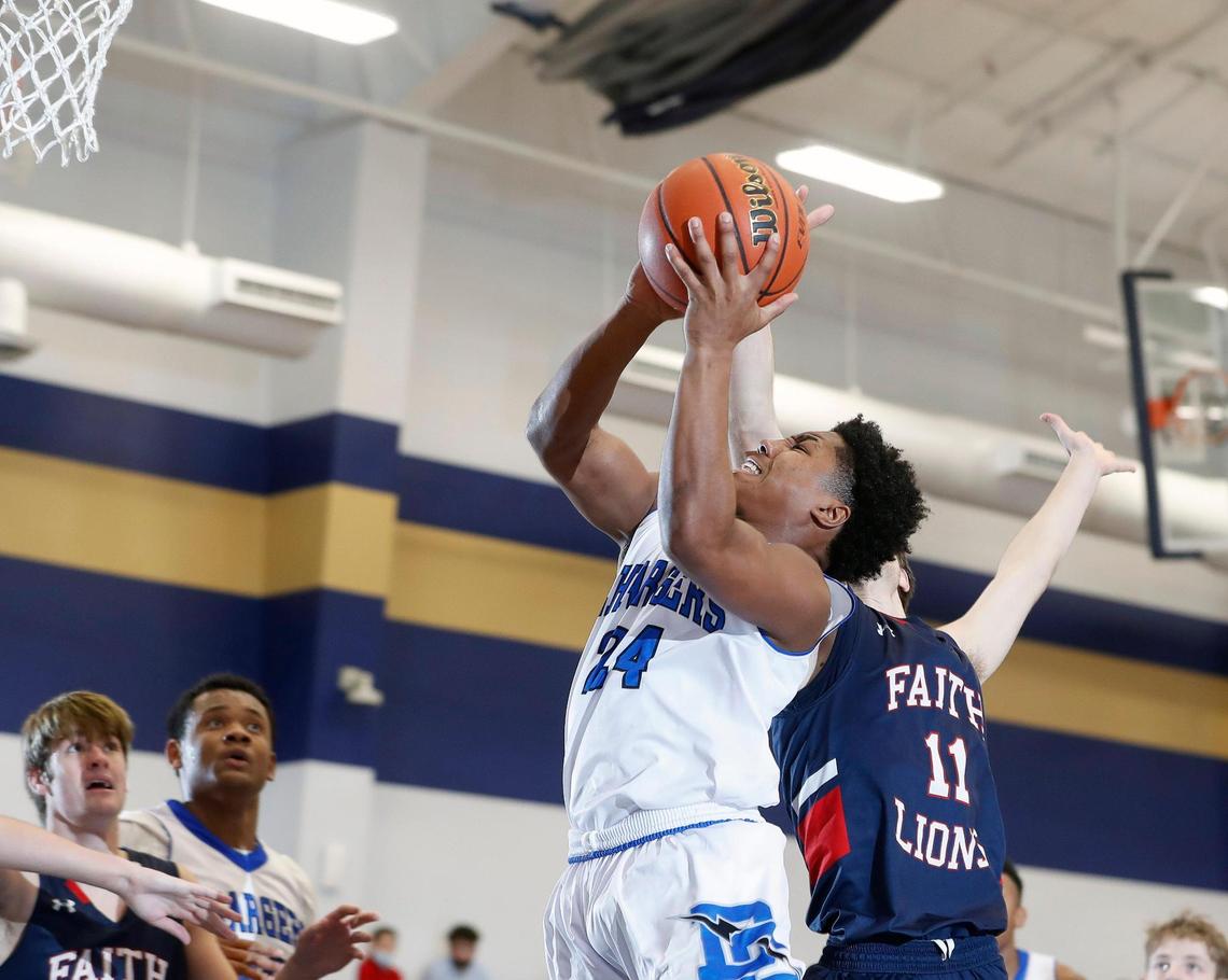 Dallas Christian guard Shon Coleman (24) shoots defended by Grapevine Faith’s Ryan Blevins (11) during the TAPPS 5A regional basketball playoff game at Grace Prep in Arlington, Texas, Saturday, March 06, 2021. Grapevine Faith defeated Dallas Christian 52-48. (Special to the Star-Telegram Bob Booth)