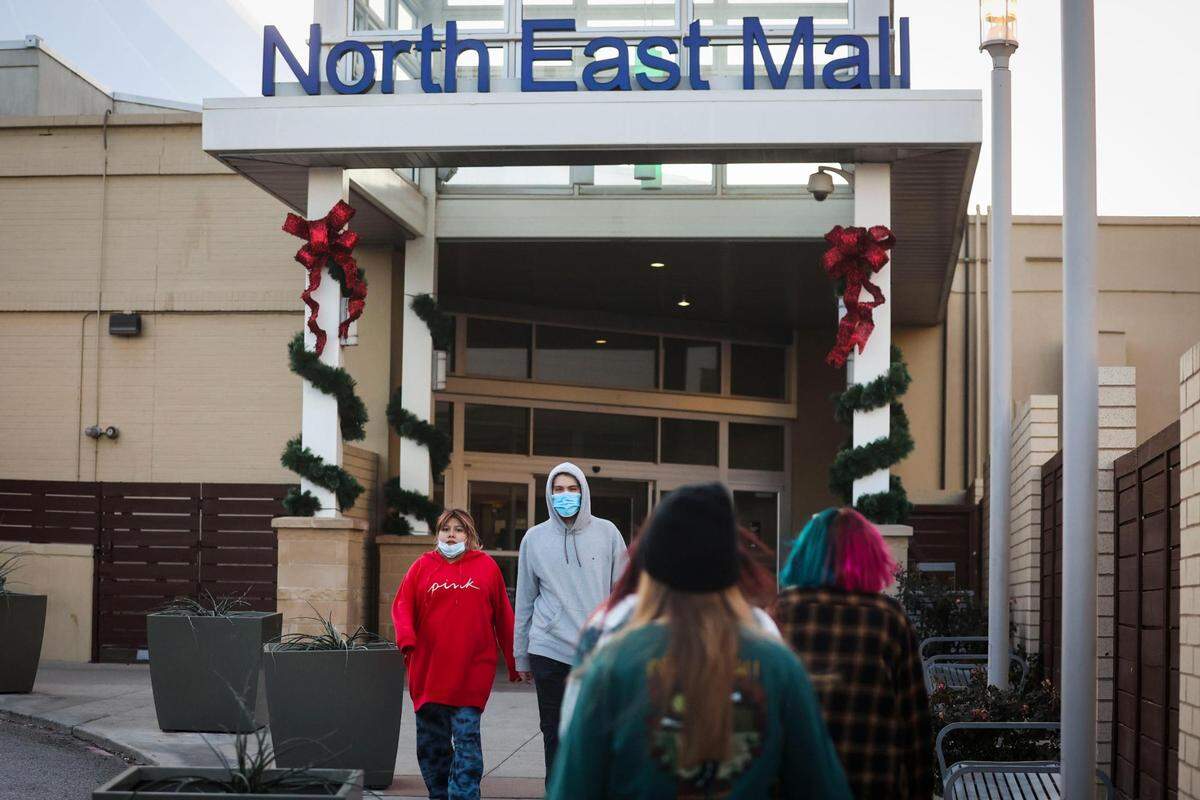 People wear masks as they exit the mall amid a COVID surge Thursday, Jan. 6, 2022, North East Mall in Hurst.