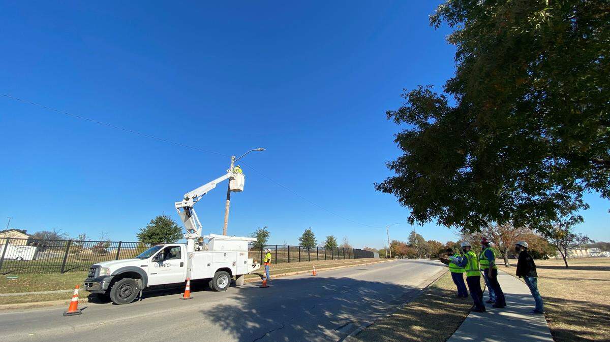 Fort Worth utility crews install Wi-Fi routers in Rosemont. The city is rolling out a fiber optic network that will make high speed internet more available.