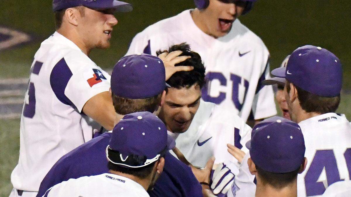 TCU's Johnny Rizer, center, celebrates with teammates at the dugout after hitting a solo home run to give the Horned Frogs a 6-4  lead  against Texas Tech in the eighth inning.