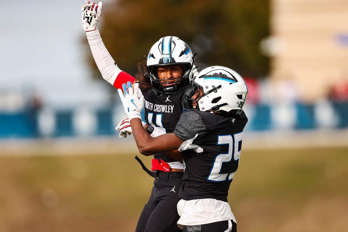 North Crowley returner Braylen Cunningham (25) leaps in the air with teammate Jerry Outhouse (4) after a play in a Class 6A Division I regional playoff against Coppell on Saturday, Nov. 29, 2025, at Midlothian ISD Stadium in Midlothian.