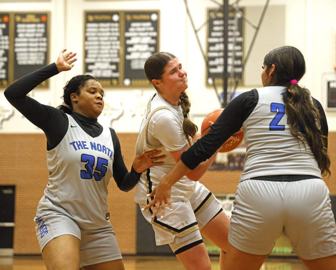 Mansfield shooting forward Kylie Farnan (24) gets double teamed by North Crowley center London Campbell (35) and forward Sandy Cortez (24) during the first half of a UIL girls basketball game between North Crowley and Mansfield at Mansfield High School in Mansfield, Texas, Tuesday Jan. 20, 2026