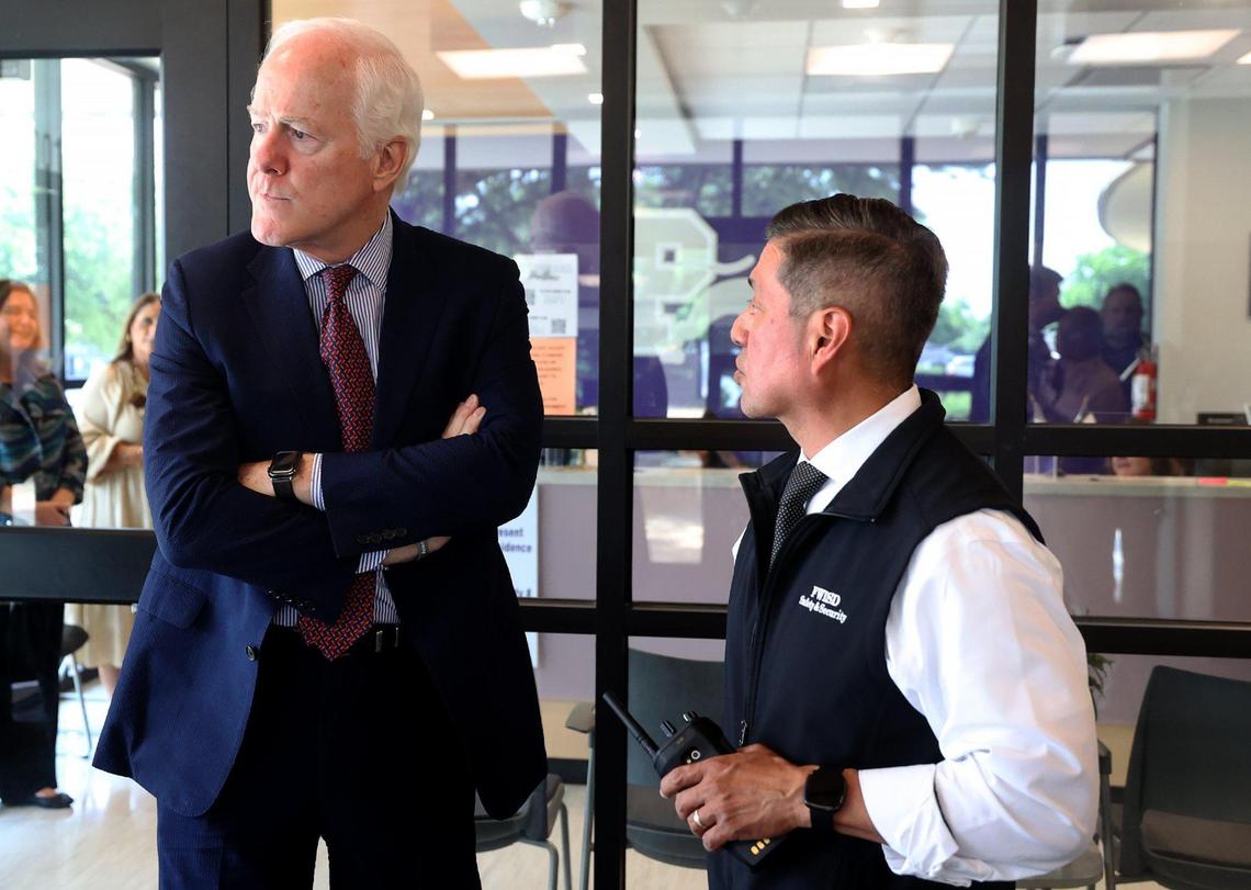Daniel Garcia, security director of the Fort Worth school district, right, explains the security at the entrance of Paschal High School to U.S. Sen. John Cornyn during a tour on Monday. The Bipartisan Safer Communities Act, which passed in 2022, provided grant money to the Fort Worth school district for its school safety program.