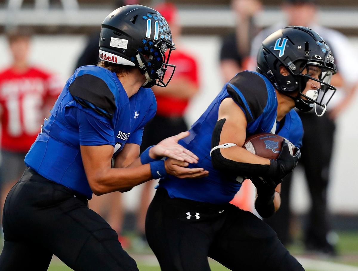 Byron Nelson’s Jacob Wilson (11) hands the ball to Michael Giordano (4) in a high school football game at NWISD Stadium in Justin, Texas, Thursday, Sept. 16, 2021. McKinney Boyd led 13-7 at the half. (Special to the Star-Telegram Bob Booth)