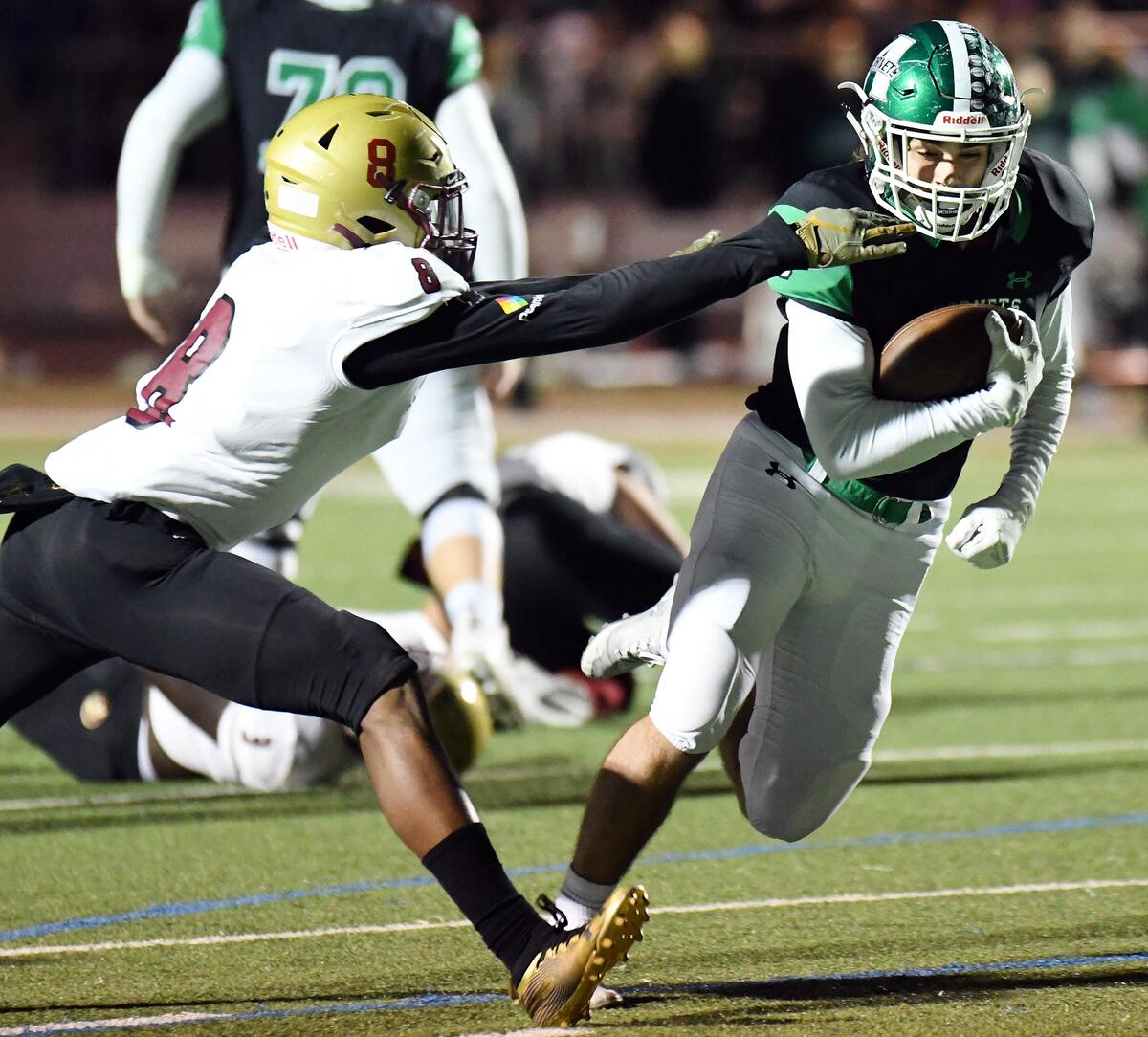 Saginaw’s Demitri Williams, left tries to reach Azle’s Jacob Lee as he breaks away for 16 yards and a touchdown to take a 14-0 lead in the first quarter during Friday’s November 1, 2019 football game at Hornet Stadium in Azle, Texas.