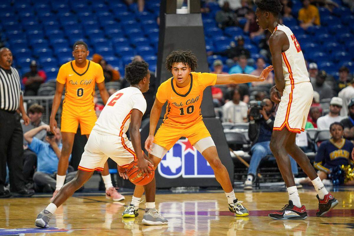 Dallas Oak Cliff Faith Family’s Isaac Williams (10) guards Stafford’s Michael Fontenot-Ross (2) while trying to avoid the screen by Dame Salane (23) in a Class 4A state semifinal on Friday, March 8, 2024 at the Alamodome in San Antonio, Texas. Faith Family defeated Stafford 59-40.