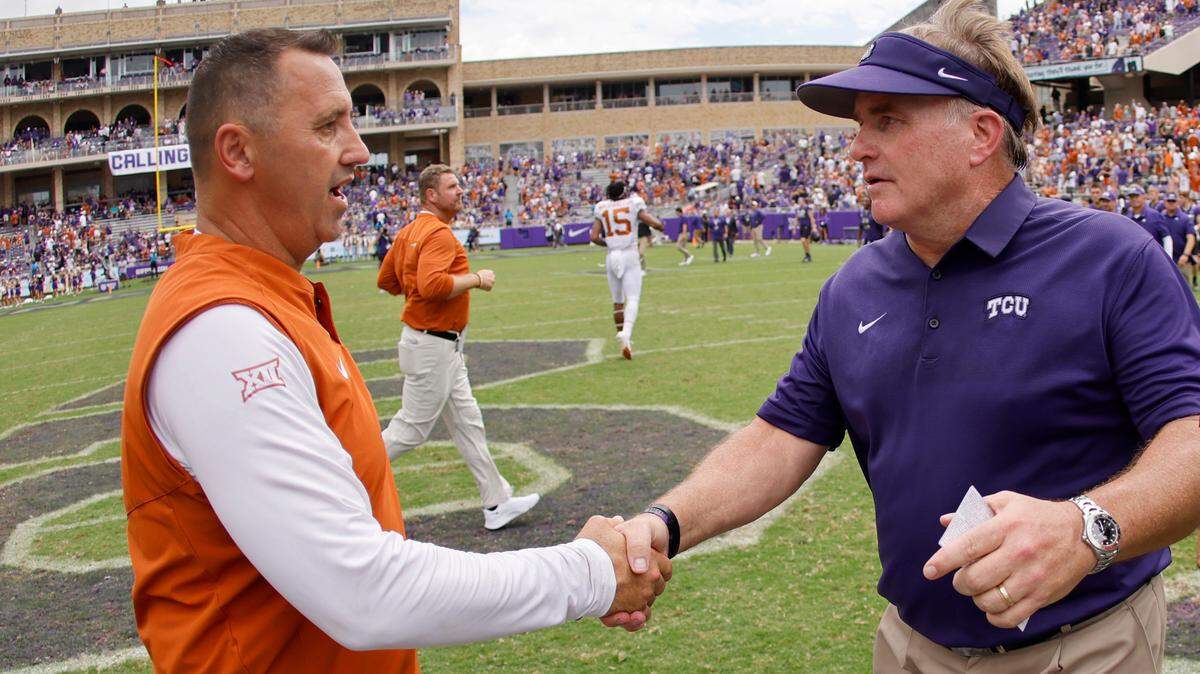 Texas head coach Steve Sarkisian meets TCU head coach Gary Patterson following Texas’ 32-27 win over TCU in an NCAA college football game Saturday, Oct. 2, 2021, in Fort Worth, Texas. (AP Photo/Ron Jenkins)