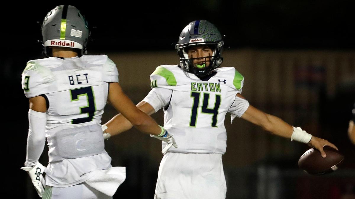 Eaton wide receiver Talan Holmes (3) congratulates quarterback Noah Lugo (14) after Lugo’s touchdown run put Eaton up 45-17 in the second half of a District 4-6A high school football game at Keller ISD Stadium in Keller, Texas, Thursday, Oct. 06, 2022. Eaton defeated Keller Central 45-17. (Special to the Star-Telegram Bob Booth)