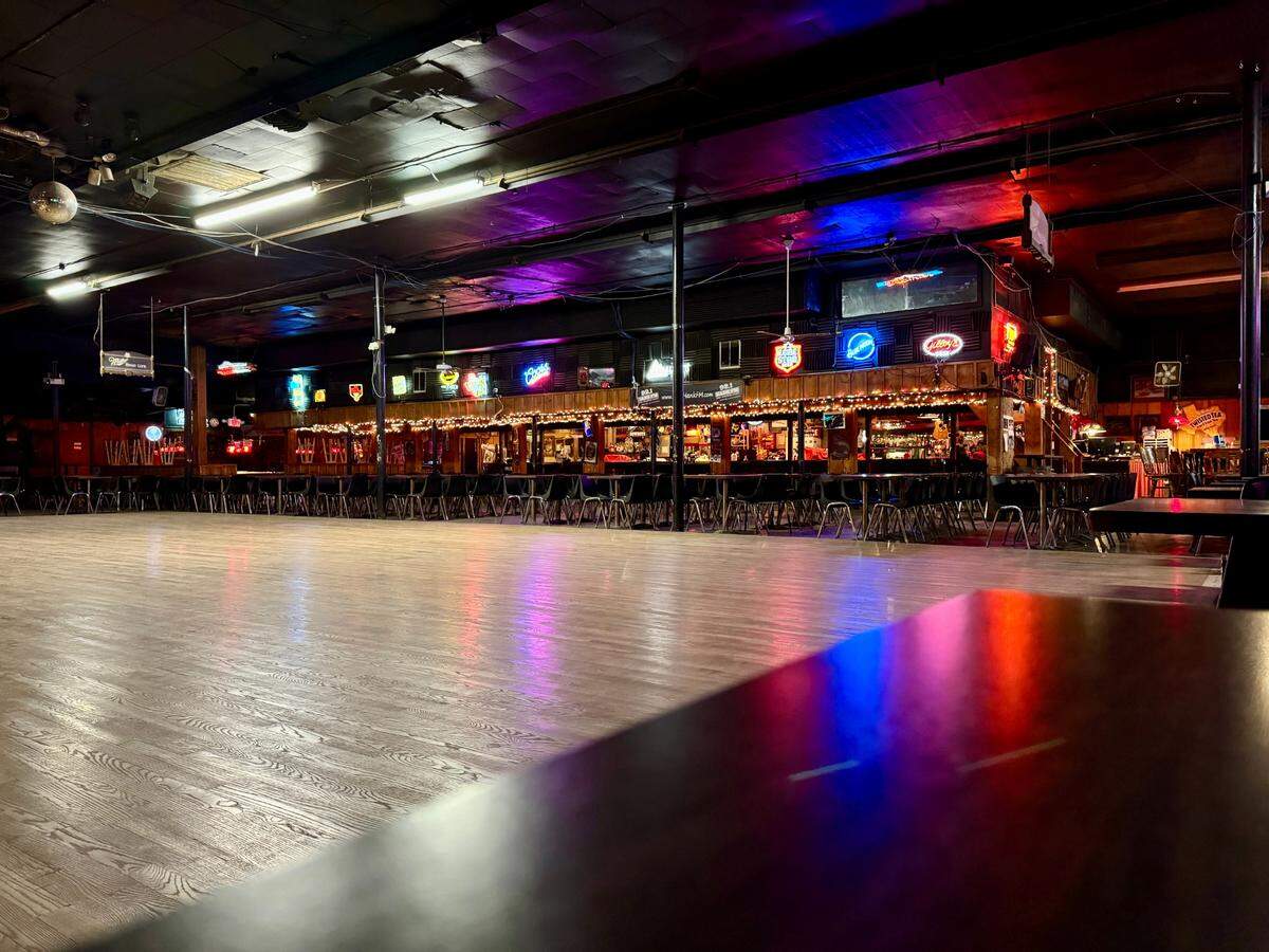 A wide shot showcasing the expansive dance floor, seating and bar area.