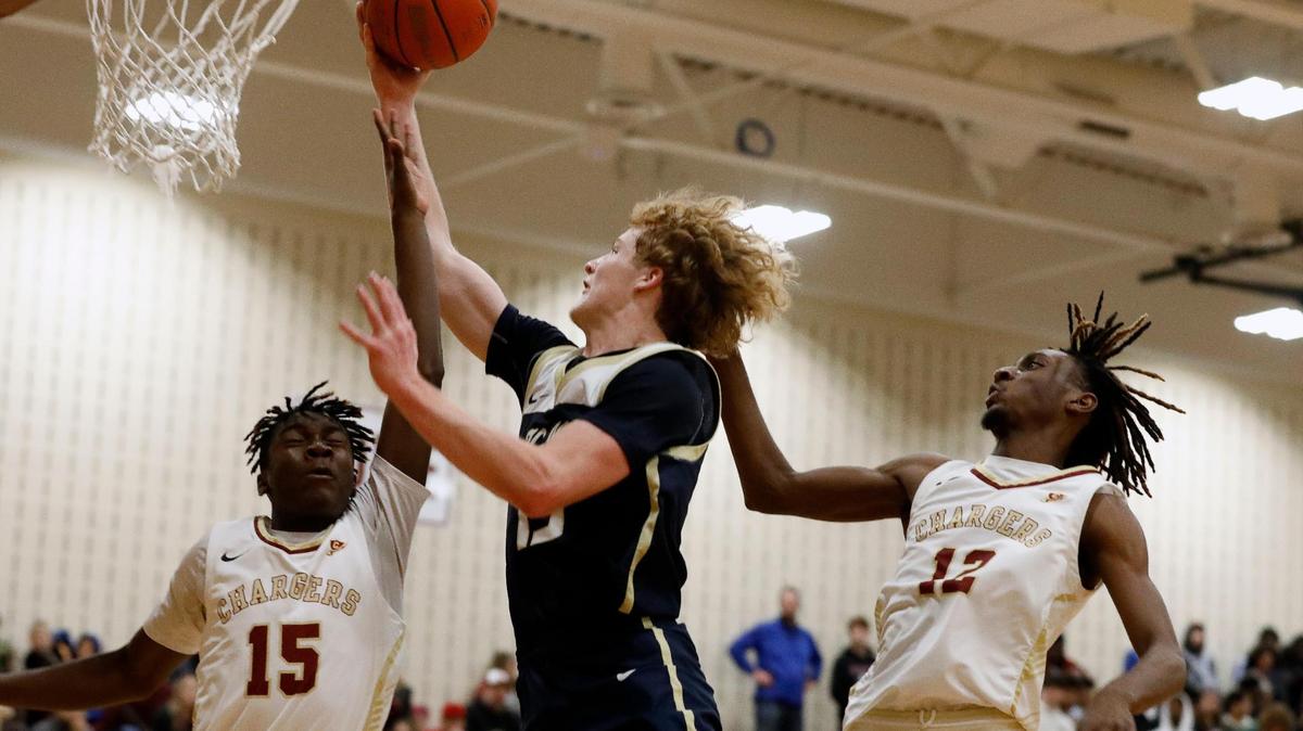 Keller’s Brooks Bahr (13) shoots between Central guard Jordan Blair (15) and forward Winston Jones (12) during the second half of a 4-6A high school basketball game at Keller Central High School in Keller, Texas, Friday, Jan. 20, 2023. Keller defeated Central 66-58. (Special to the Star-Telegram Bob Booth)