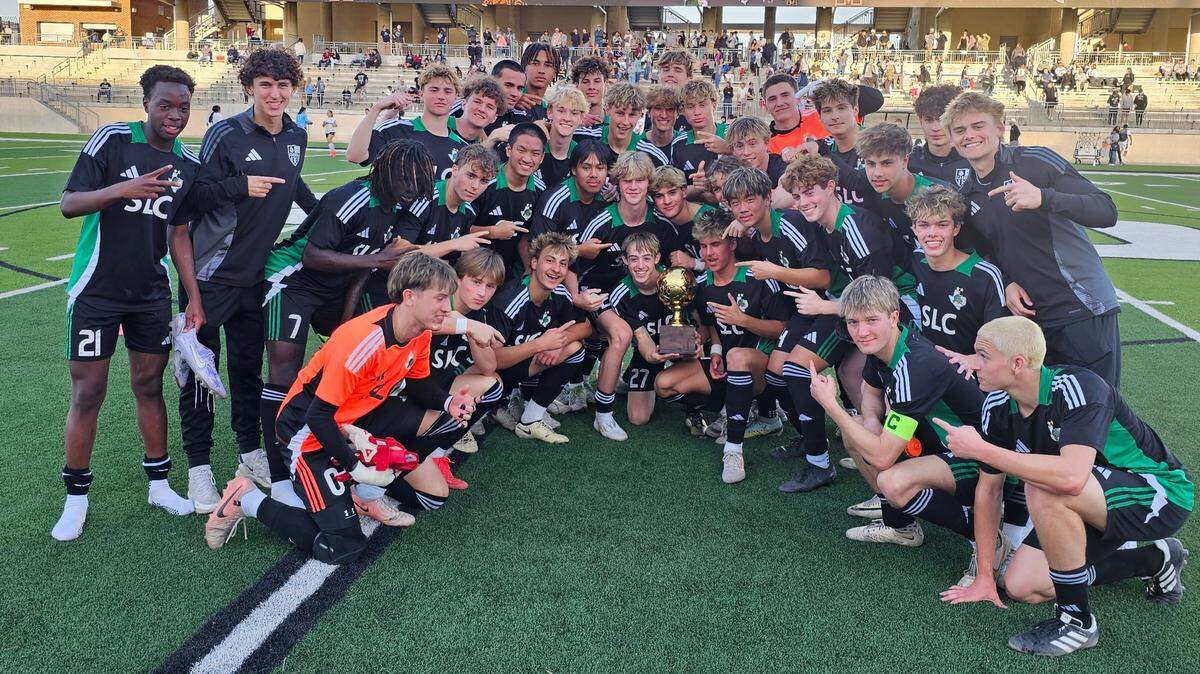The Southlake Carroll boys soccer team poses with the trophy after defeating Mansfield in a Class 6A Division 2 bi-district match on Friday, March 21, 2025 at Crowley ISD Multi-Purpose Stadium in Fort Worth, Texas. Carroll won 3-0.