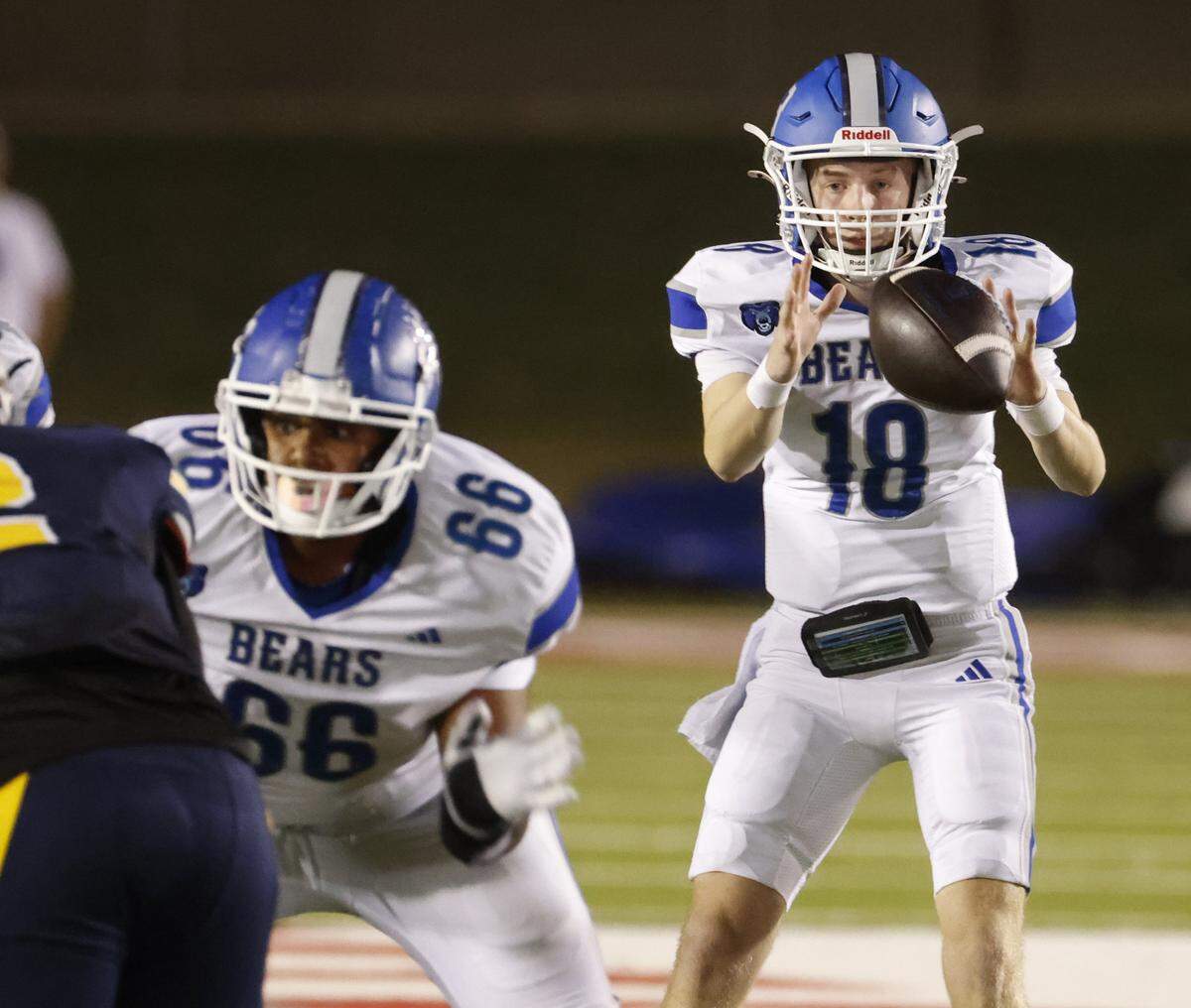 Brewer quarterback Colton Ryals (18) takes the snap during the first half of a UIL Conference 5A D1 Bi-District playoff game between Arlington Heights and Brewer at Farrington Field in Fort Worth, Texas, Friday, Nov. 14, 2025.