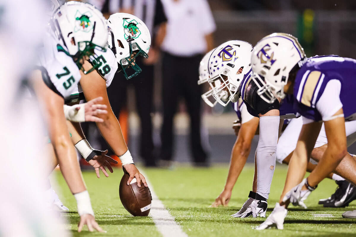 Southlake Carroll center Christian Gonzalez (59) holds the ball at the line of scrimmage before a snap against Keller Timber Creek defender during a district matchup on Thursday, September 25, 2025 at Keller ISD Stadium in Keller, Texas.