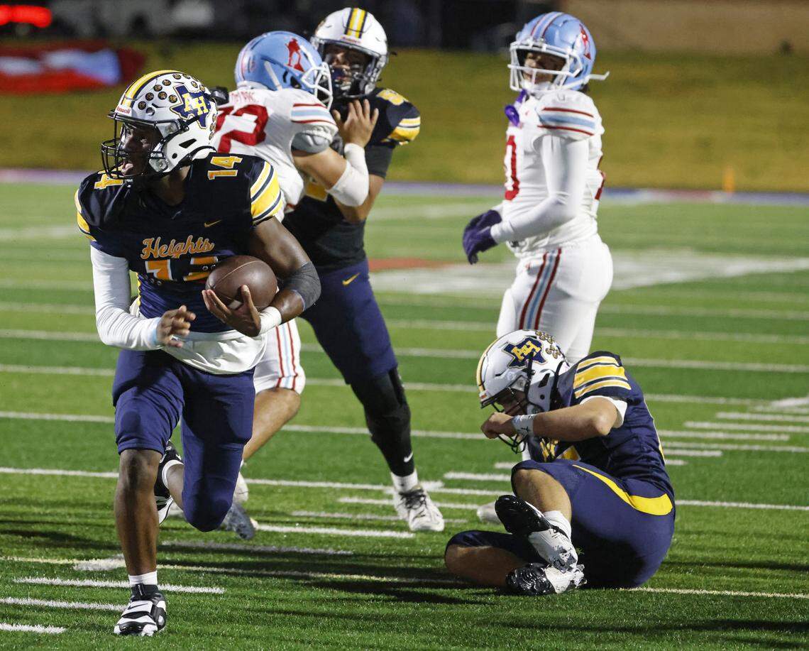 Fort Worth Arlington Heights quarterback Carmelo Carter (14) heads to the end zone for six during the first half of a UIL Class 5A DI area-round football playoff game Thursday Nov. 20, 2025 at Shotwell Stadium in Abilene, Texas.